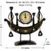 Decorative handcrafted metal boat-shaped table clock with colorful traditional Indian artwork, displayed on a wooden living room table.
