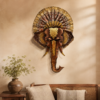 Decorative elephant face wall art with an ornate golden crown and traditional Indian detailing, displayed in a rustic stylish living room.