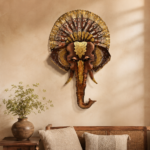 Decorative elephant face wall art with an ornate golden crown and traditional Indian detailing, displayed in a rustic stylish living room.