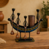 Set of three colorful handcrafted Rajasthani-style metal figurines with traditional turbans and folk-art detailing, displayed in decorative arched frames.