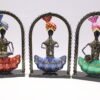 Set of three colorful handcrafted Rajasthani-style metal figurines with traditional turbans and folk-art detailing, displayed in decorative arched frames.