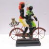 Handcrafted Rajasthani couple riding a bicycle, featuring colorful traditional attire and detailed metalwork on a decorative black base.
